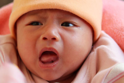 Close up portrait of little cute baby girl crying