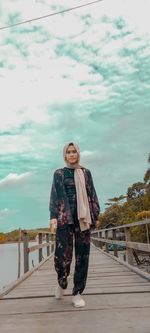 Portrait of smiling man standing against sky