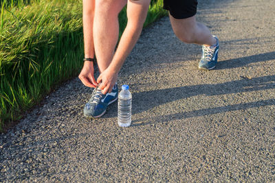 Low section of person running on road