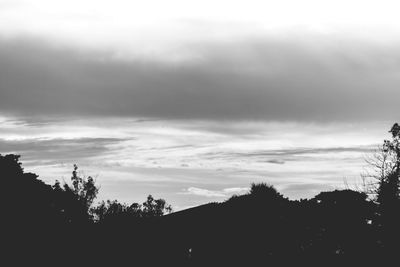 Low angle view of silhouette trees against sky at sunset