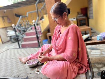 A perfect home maker mother peeling vegetables for all the persons in a home