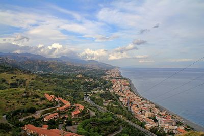 View of the long coast, buildings close to the beach, ionian sea, hilly and hills, sicily, taormina