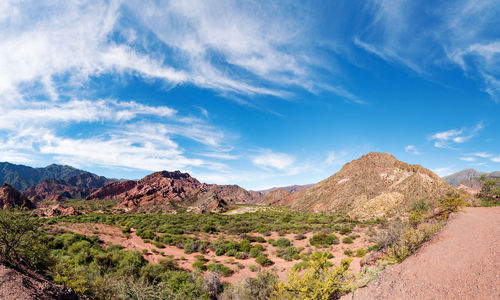 Scenic view of mountains against blue sky