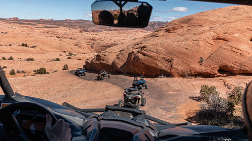 Full frame view of a 4x4 tour in rugged sandstone terrain on a trail called hell's revenge