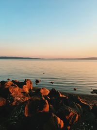 Scenic view of sea against clear sky at sunset