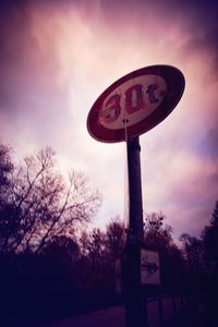 Low angle view of road sign against sky