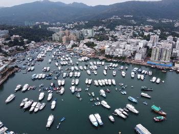 High angle view of sea and boats in city