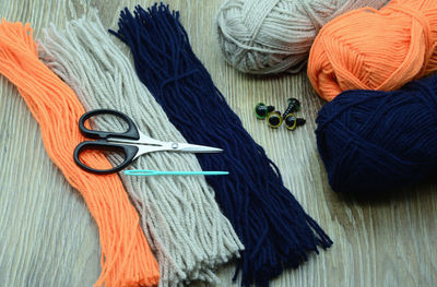 High angle view of wool and scissors on table