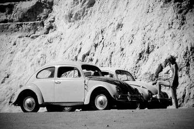 Side view of old car on road
