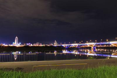 Illuminated cityscape against night sky