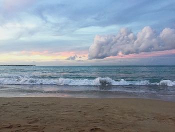 Scenic view of beach against sky during sunset