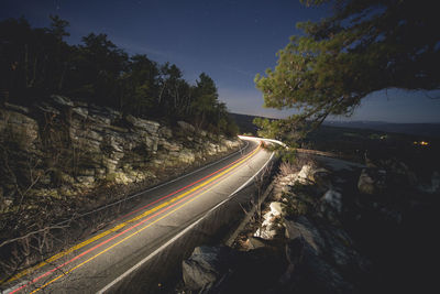 Light trails on road in city at night