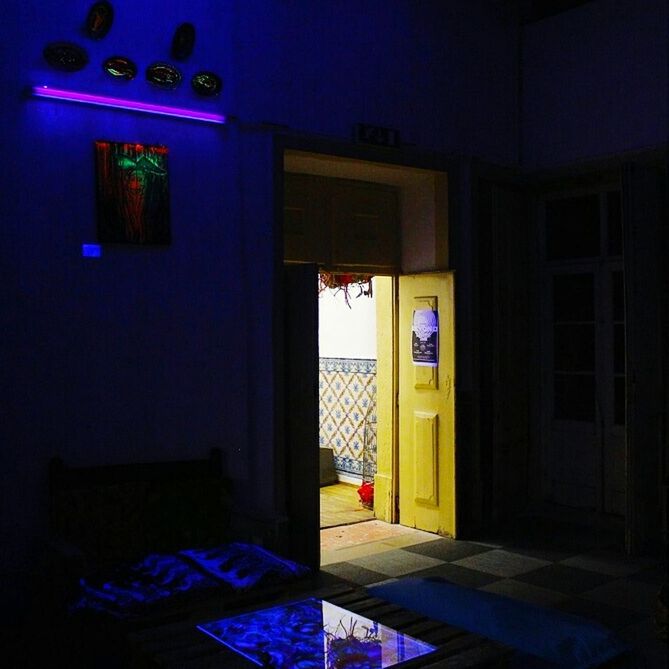 architecture, built structure, indoors, house, illuminated, door, absence, building exterior, empty, entrance, doorway, night, home interior, residential structure, no people, blue, window, closed, room, chair