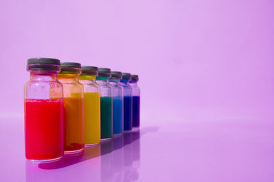 Close-up of multi colored glass bottle on table