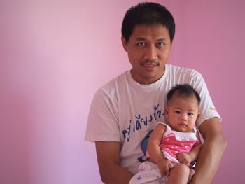 Portrait of happy mother holding baby