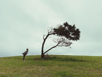 Man standing on field against sky