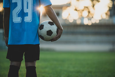 Man playing soccer ball on grass