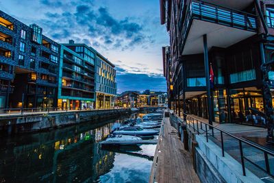 Boats moored in city against sky