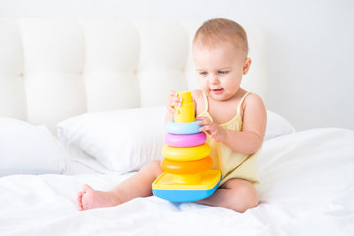 Portrait of cute baby boy sleeping on bed at home