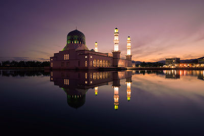 Reflection of illuminated building in lake