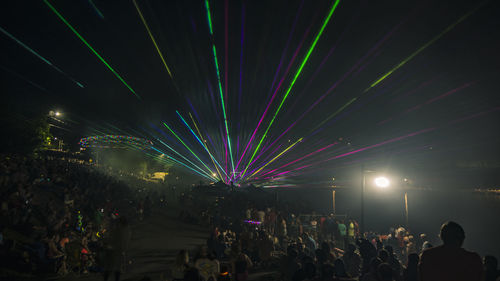 Crowd at illuminated music concert at night