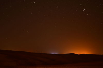 Scenic view of mountains against sky at night