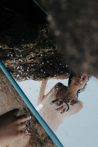 High angle view of woman reflecting on mirror