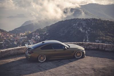 Cars on mountain against sky