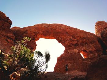 Low angle view of rock formation against clear blue sky