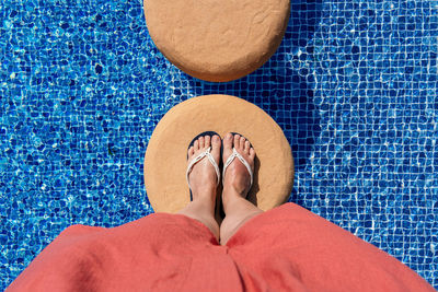 Low section of woman standing on tiled floor