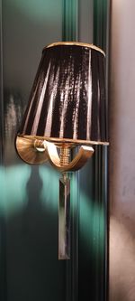 Close-up of electric lamp on wall