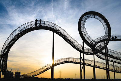 Low angle view of rollercoaster against sky