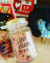 Close-up of hand holding drink in jar