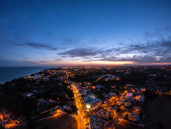 High angle view of illuminated city buildings at night