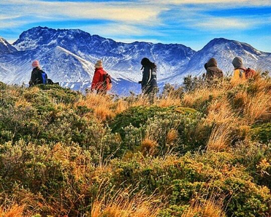 mountain, landscape, sky, mountain range, tranquil scene, beauty in nature, tranquility, scenics, grass, field, nature, plant, non-urban scene, leisure activity, cloud - sky, lifestyles, men, growth