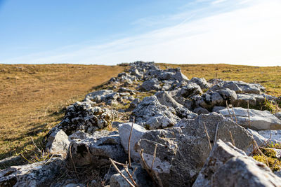 Rocks on land against sky on mountain linzone