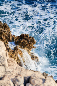 Waves splashing on rocks at shore