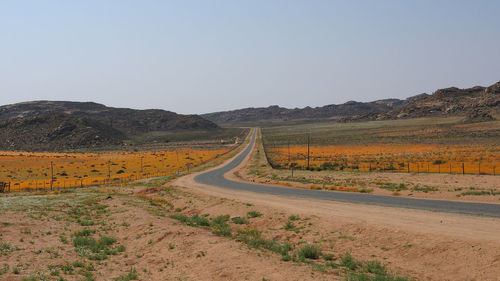 Empty road along countryside landscape