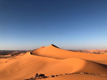Scenic view of desert against clear sky