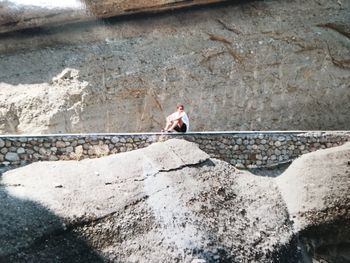 High angle view of man standing on rock météore greece 2000 year