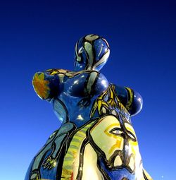 Low angle view of statue against clear blue sky