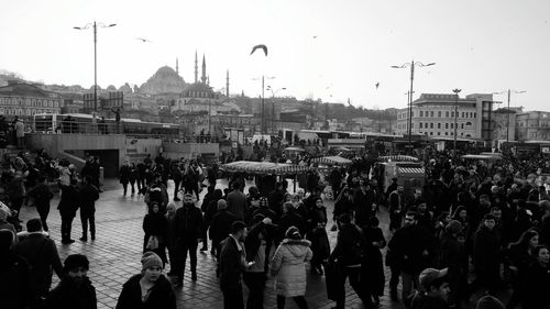 People on street in city against sky