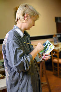 Side view of woman holding umbrella