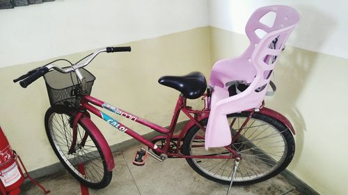 Bicycle parked against wall