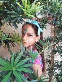 Portrait of teenage girl against plants