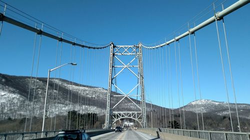 Suspension bridge against clear blue sky