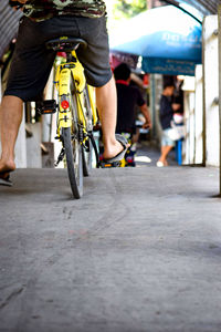 Rear view of man riding bicycle on road