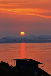 Scenic view of sea against orange sky