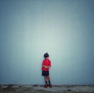 Full length of woman standing on railing