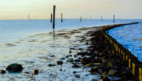 Scenic view of beach against sky during winter